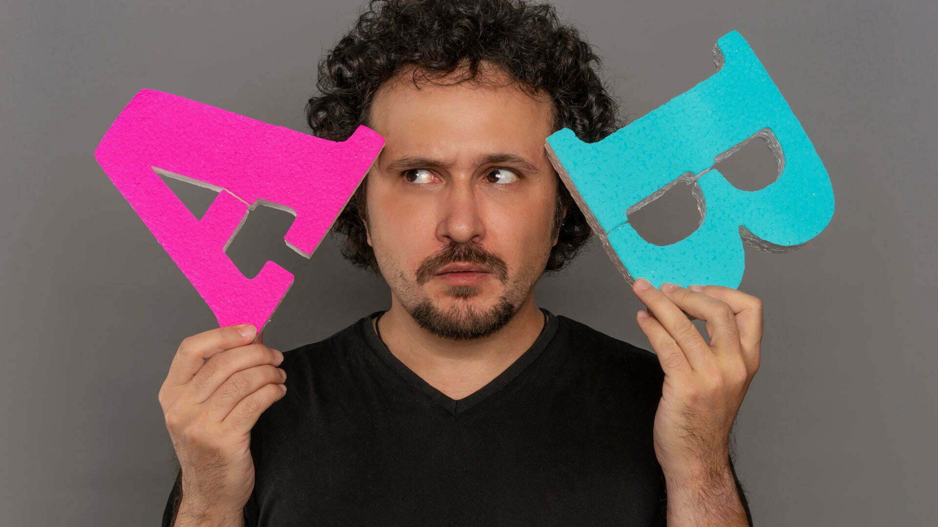Man Holding 3D Letters 'A' and 'B' next to his head